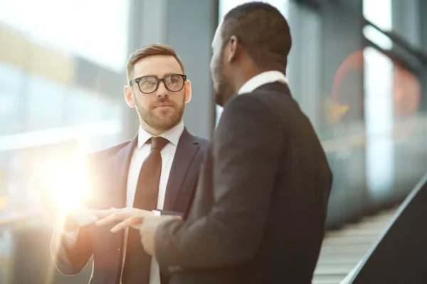 Two executives exchanging insights during a business event—symbolizing thought leadership and strategic news coverage