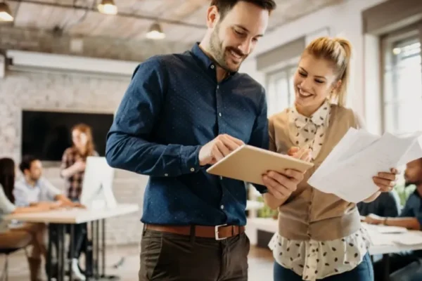 Business owners reviewing financial reports—symbolizing foundational strategic tax & executive advisory support to bridge day-to-day management and long-term strategy