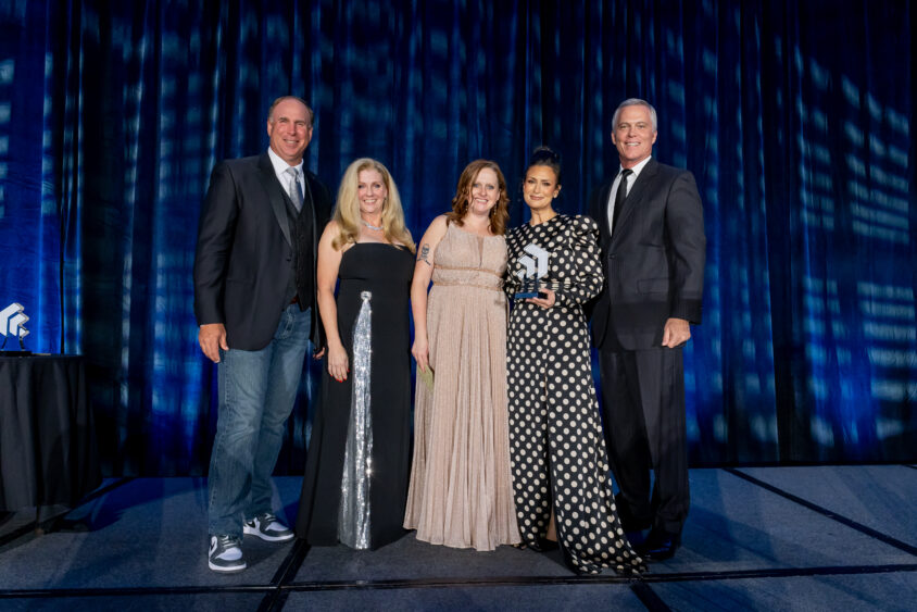 Michelle Delker of The William Stanley Group on stage with fellow honorees at the 2024 Small Business of the Year Awards hosted by the Tampa Bay Chamber.