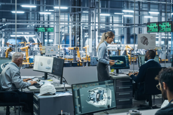 Team of professionals working in a high-tech industrial office, representing The William Stanley Group's feature in GENCFO on CFO automation and digital transformation.