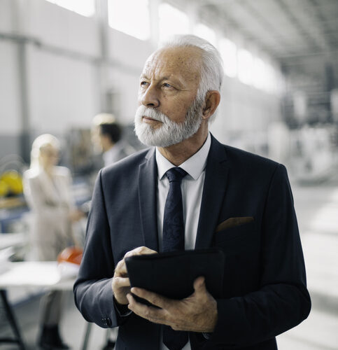 Colleagues talking business in factory
